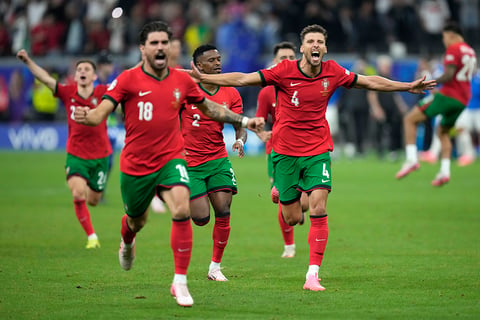 Portugal's players celebrate after winning the penalties